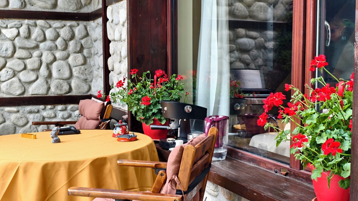 Outdoor dining corner with flowers at the riverside villa